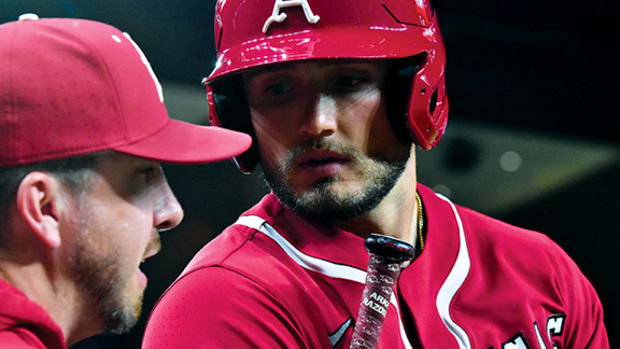 Arkansas hitter Jared Wegner talks strategy before going up to bat against the Texas Longhorns.